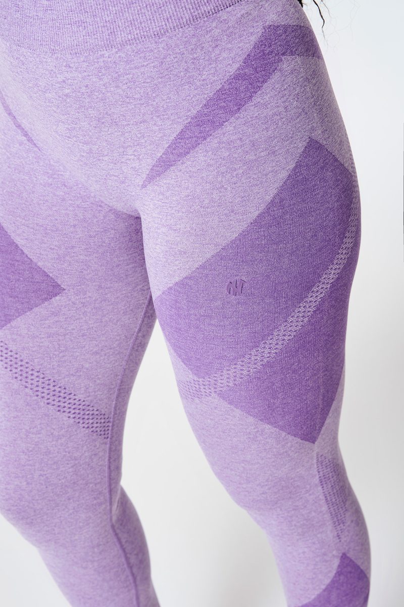 Close-up of the front of a Black woman’s leg, wearing Violet Bold Seamless Performance Leggings, with the NexLevel logo visible, highlighting the sleek design and perfect fit.