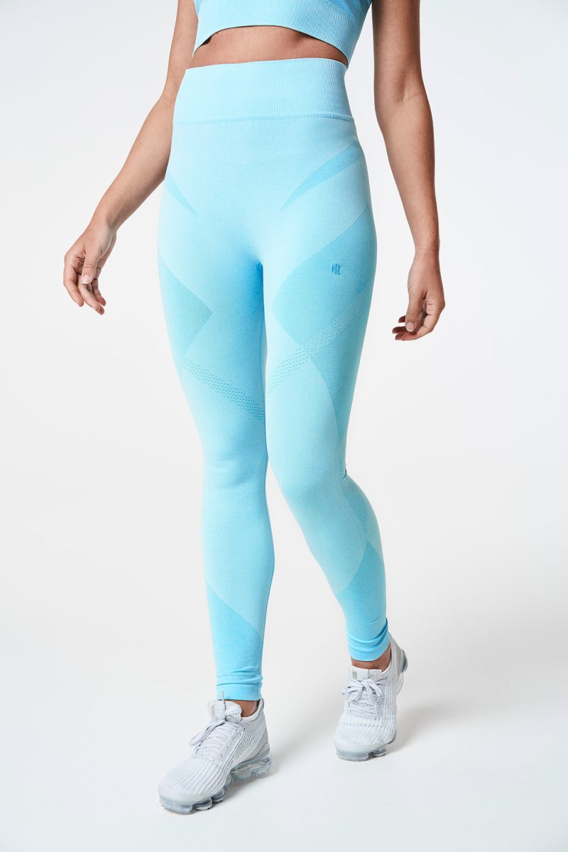 Close-up of a blonde woman’s legs walking, wearing Aqua Blue Bold Seamless Performance Leggings, emphasizing the smooth fit and dynamic movement.